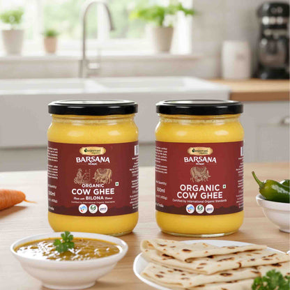 Barsana Magic and Two jars of Organic Cow Ghee on a kitchen counter with food items around.