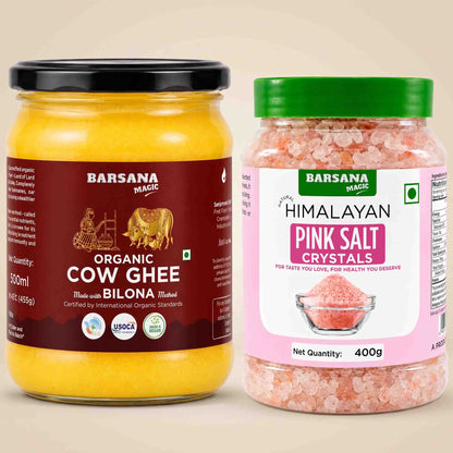 Barsana Magic and Two jars of Barsana Magic products on a beige background: a large jar of Organic Cow Ghee with a black lid and dark red label, and a smaller jar of Himalayan Pink Salt Crystals with a green lid and pink label.