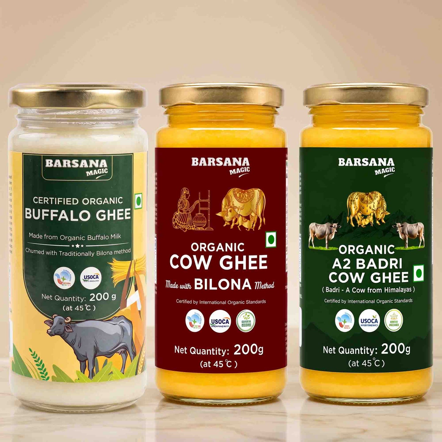 Barsana Magic and Three jars of Barsana Magic ghee products displayed side-by-side on a light beige background. The left jar contains Organic Buffalo Ghee with a yellow and green label; the middle jar contains Organic Cow Ghee with a maroon and gold label; the right jar contains A2 Badri Cow Ghee with a dark green and gold label.