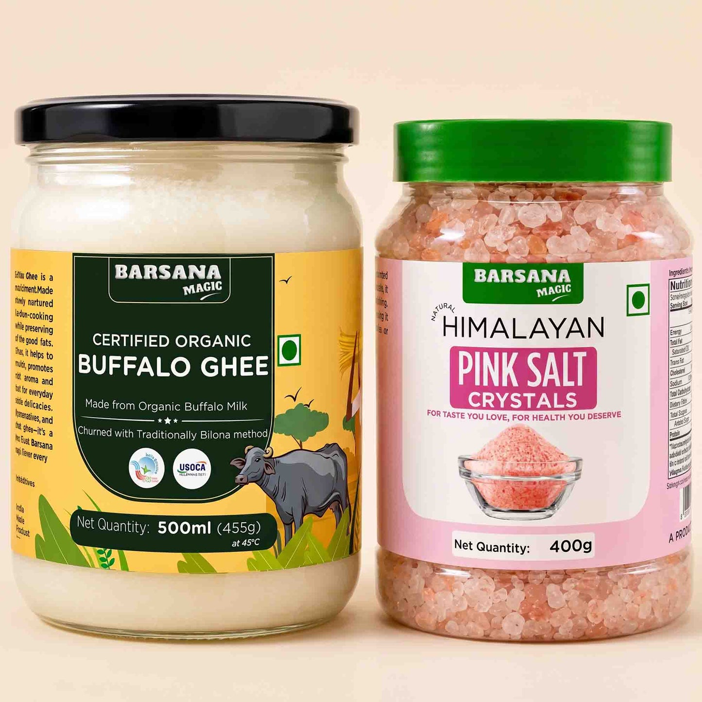 Barsana Magic and Two jars of Barsana Magic products on a light beige background: a 500ml jar of Certified Organic Buffalo Ghee with a black lid and yellow label, and a 400g jar of Himalayan Pink Salt Crystals with a green lid and pink label.