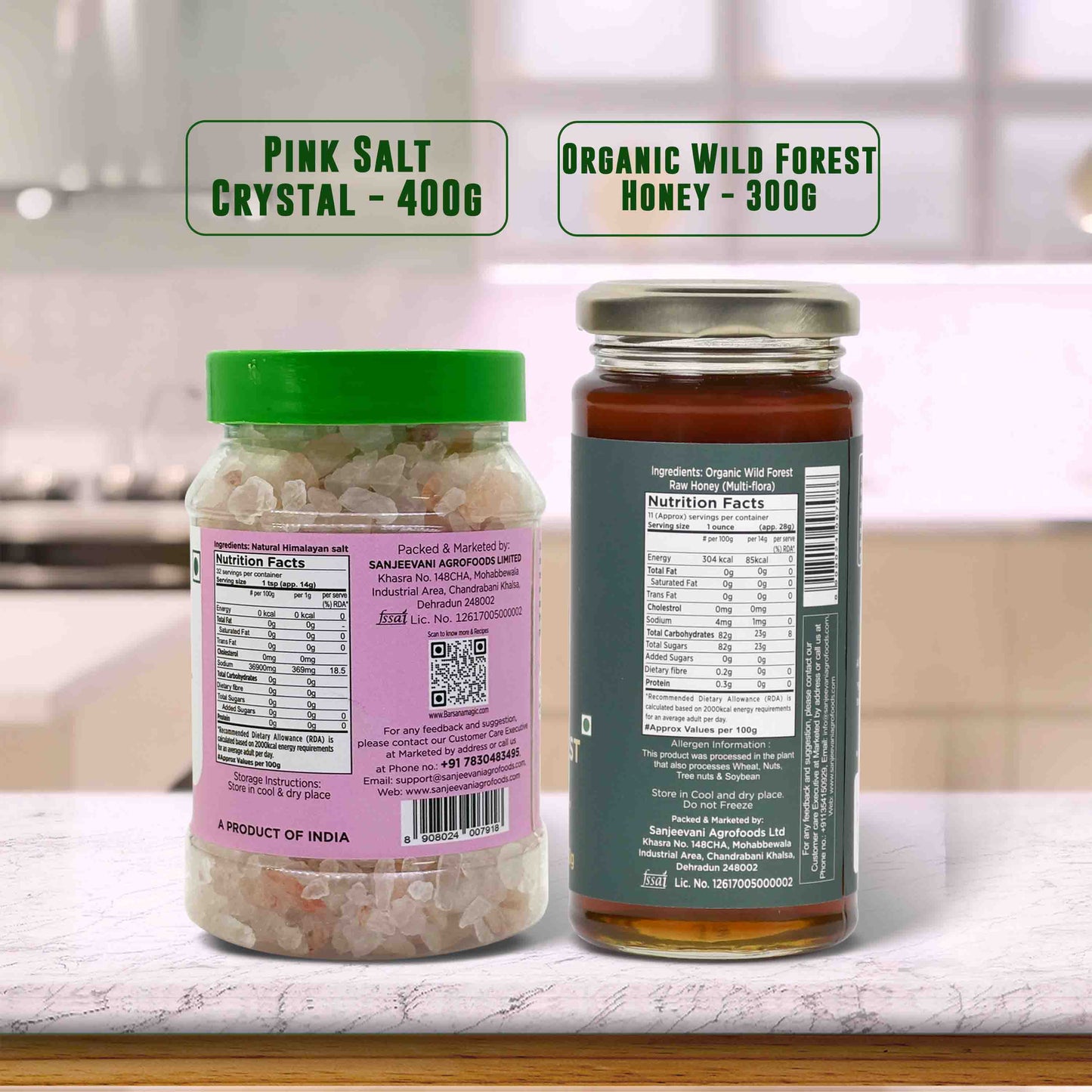 Barsana Magic and Two jars labeled 'Pink Salt Crystal' and 'Organic Wild Forest Honey' on a kitchen counter.