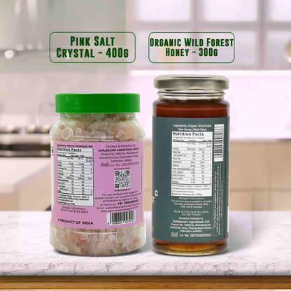 Barsana Magic and Two jars labeled 'Pink Salt Crystal' and 'Organic Wild Forest Honey' on a kitchen counter.