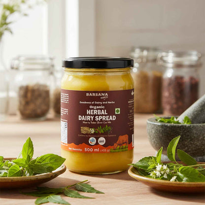 Barsana Magic and Jar of Organic Herbal Dairy Spread on a wooden surface with herbs around