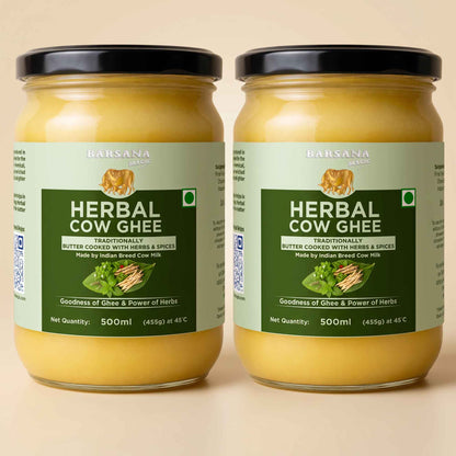 Barsana Magic and Two jars of Barsana Herbal Cow Ghee displayed side-by-side against a solid beige background. The jars are filled with a golden-yellow ghee and feature light green labels with dark green text panels, black lids, and a small illustration of a cow on each label.