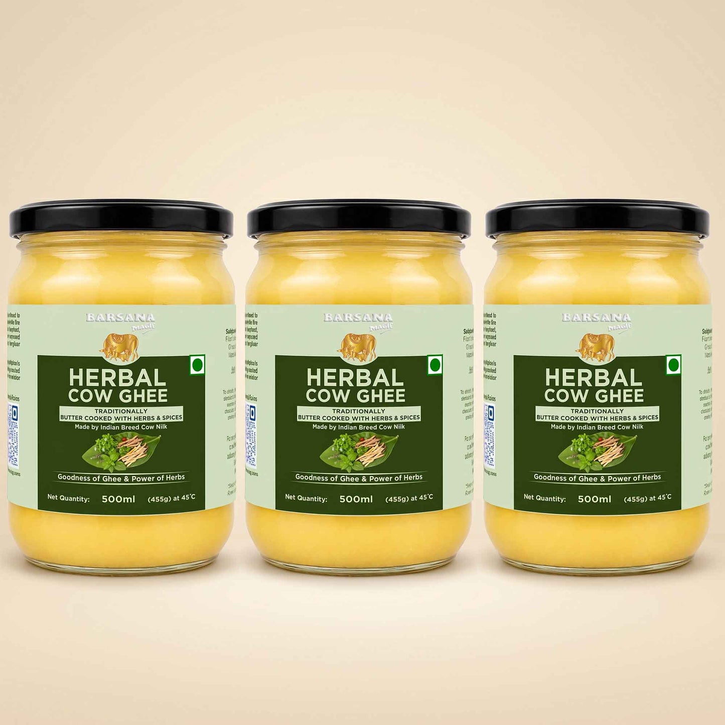 Barsana Magic and Three glass jars of Babasa Herbal Cow Ghee arranged side by side on a light beige background. The jars contain a yellow ghee and are fitted with black lids, featuring light green and dark green labels with product details.