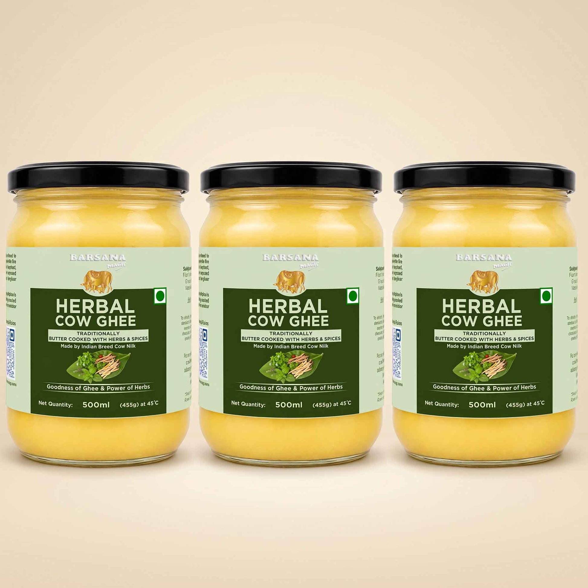 Barsana Magic and Three glass jars of Babasa Herbal Cow Ghee arranged side by side on a light beige background. The jars contain a yellow ghee and are fitted with black lids, featuring light green and dark green labels with product details.