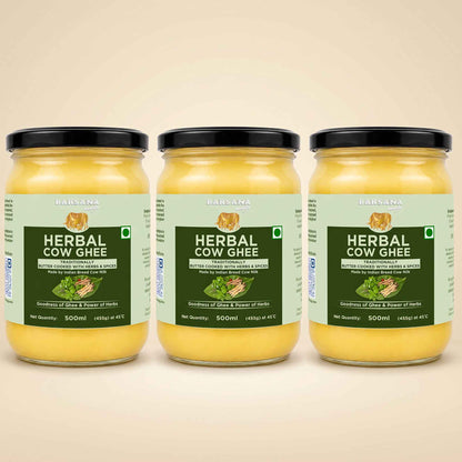 Barsana Magic and Three glass jars of Babasa Herbal Cow Ghee arranged side by side on a light beige background. The jars contain a yellow ghee and are fitted with black lids, featuring light green and dark green labels with product details.