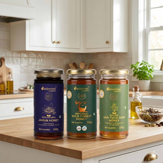 Barsana Magic and Three jars of Sanjeevani honey on a kitchen counter with cabinets and window in the background.