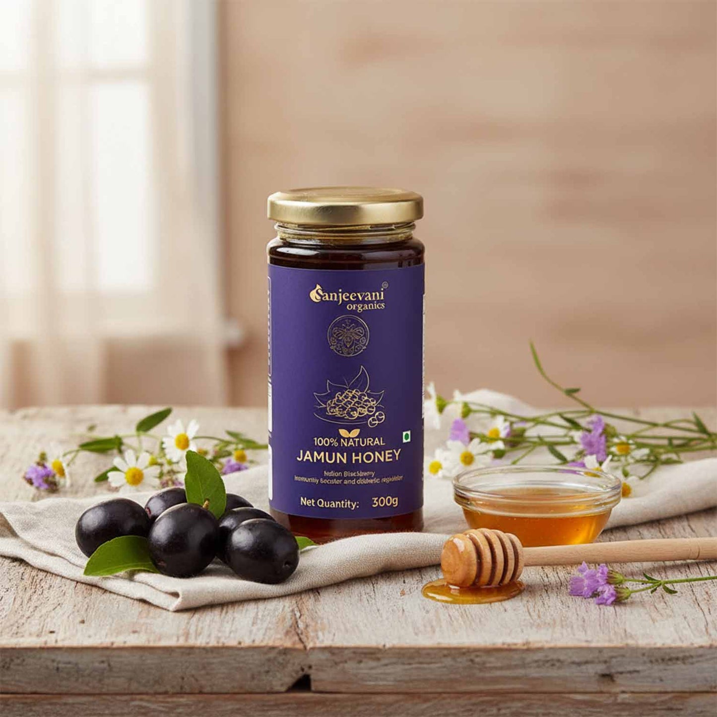 Barsana Magic and Jar of Sanjeevani Jamun Honey on a wooden table with honey dipper and jamuns.