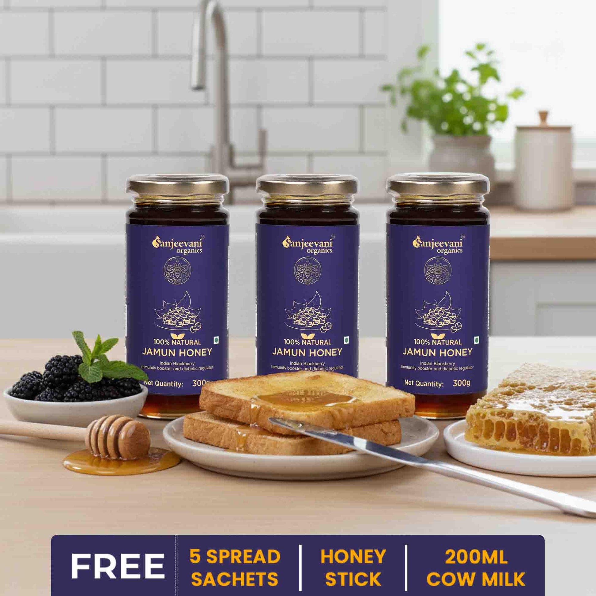 Barsana Magic and  Three jars of Sanjeevani Organics Jamun Honey on a kitchen counter with toast and honey.