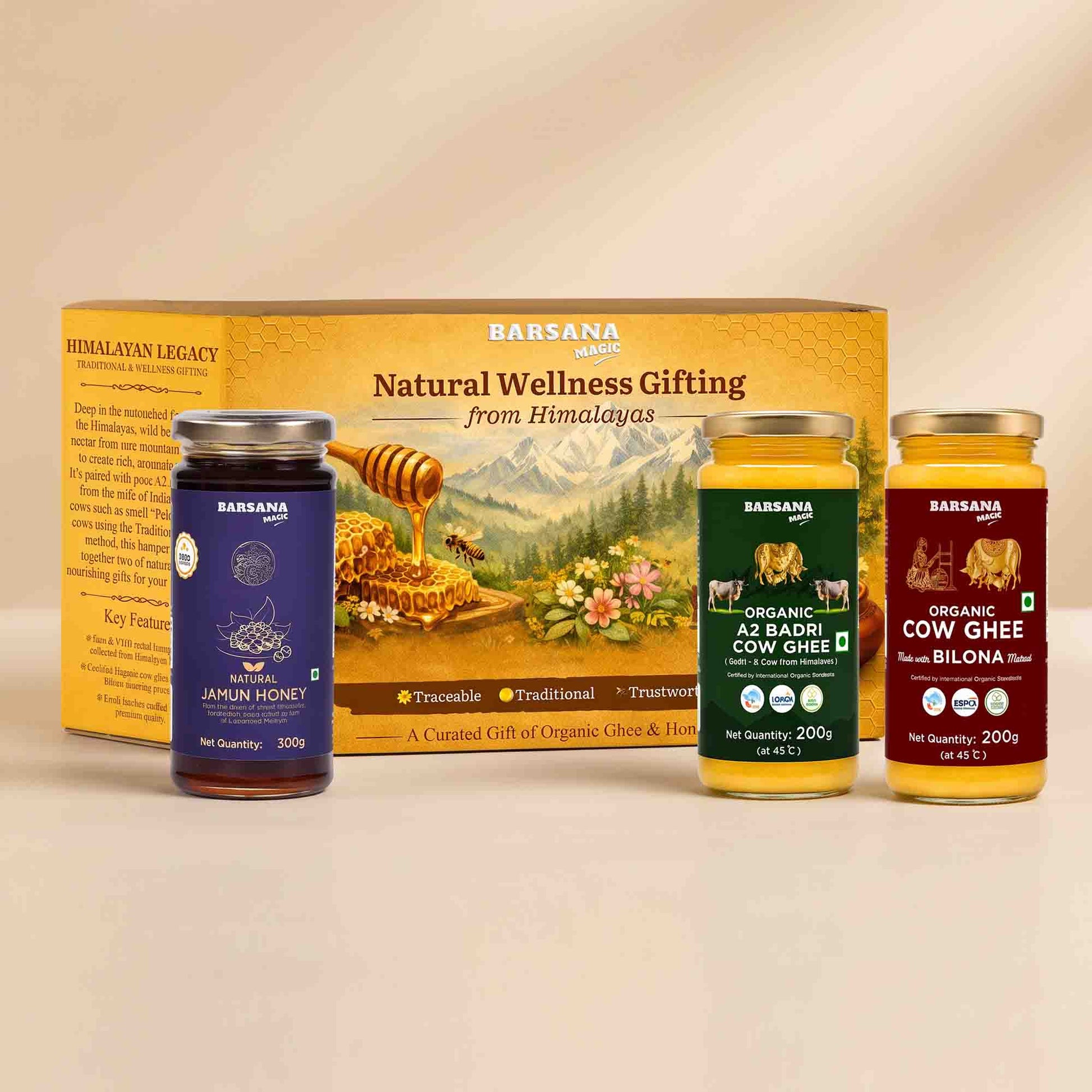 Barsana Magic and Legacy gift set containing three jars of organic and traditional honey/ghee alongside its yellow cardboard packaging box, displayed on a light beige surface against a matching beige background.