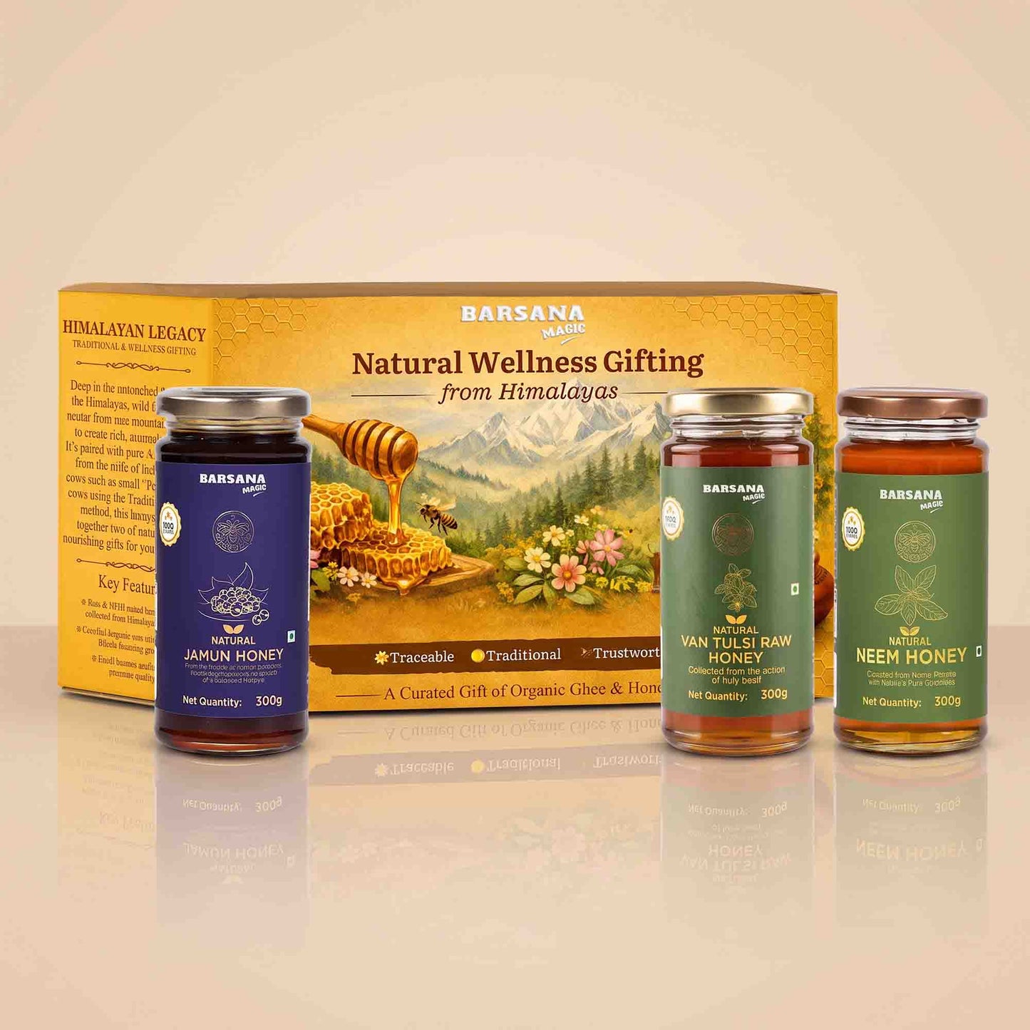Barsana Magic and A boxed honey gift set from Barsana on a warm beige background. The set includes one large yellow gift box and three glass jars of honey: dark blue Jamun Honey, amber Van Tuls Raw Honey, and green Neem Honey, all with metal lids.