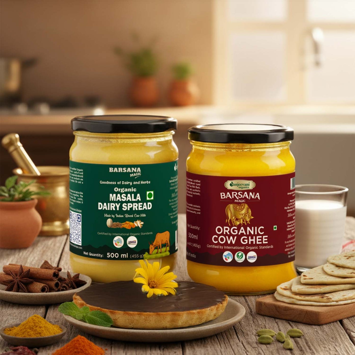 Barsana Magic and Two jars of Barsana Organic Dairy Spread on a wooden table with kitchen items in the background.