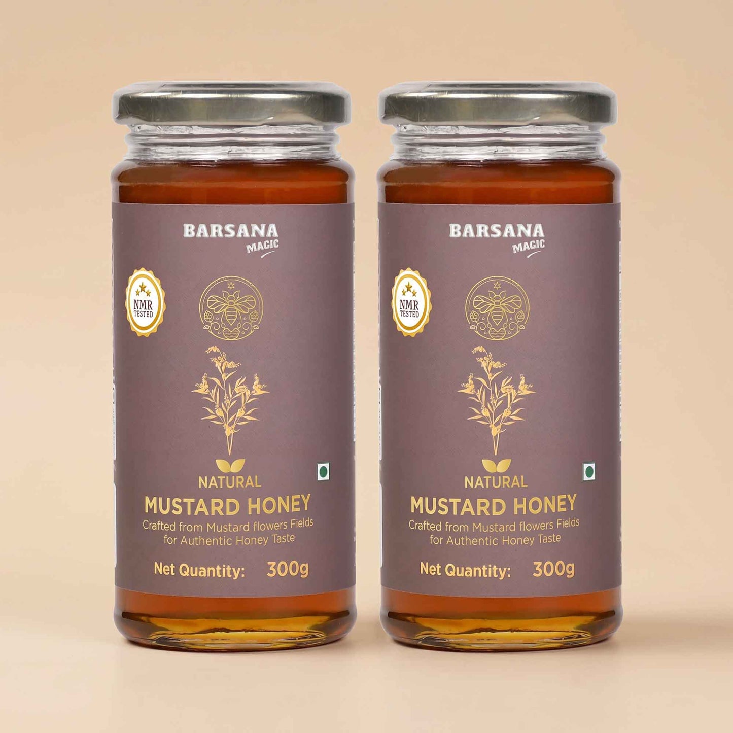 Barsana Magic and Two glass jars of Barsana Brand Natural Mustard Honey with dark brown labels and silver lids, set against a solid beige background.