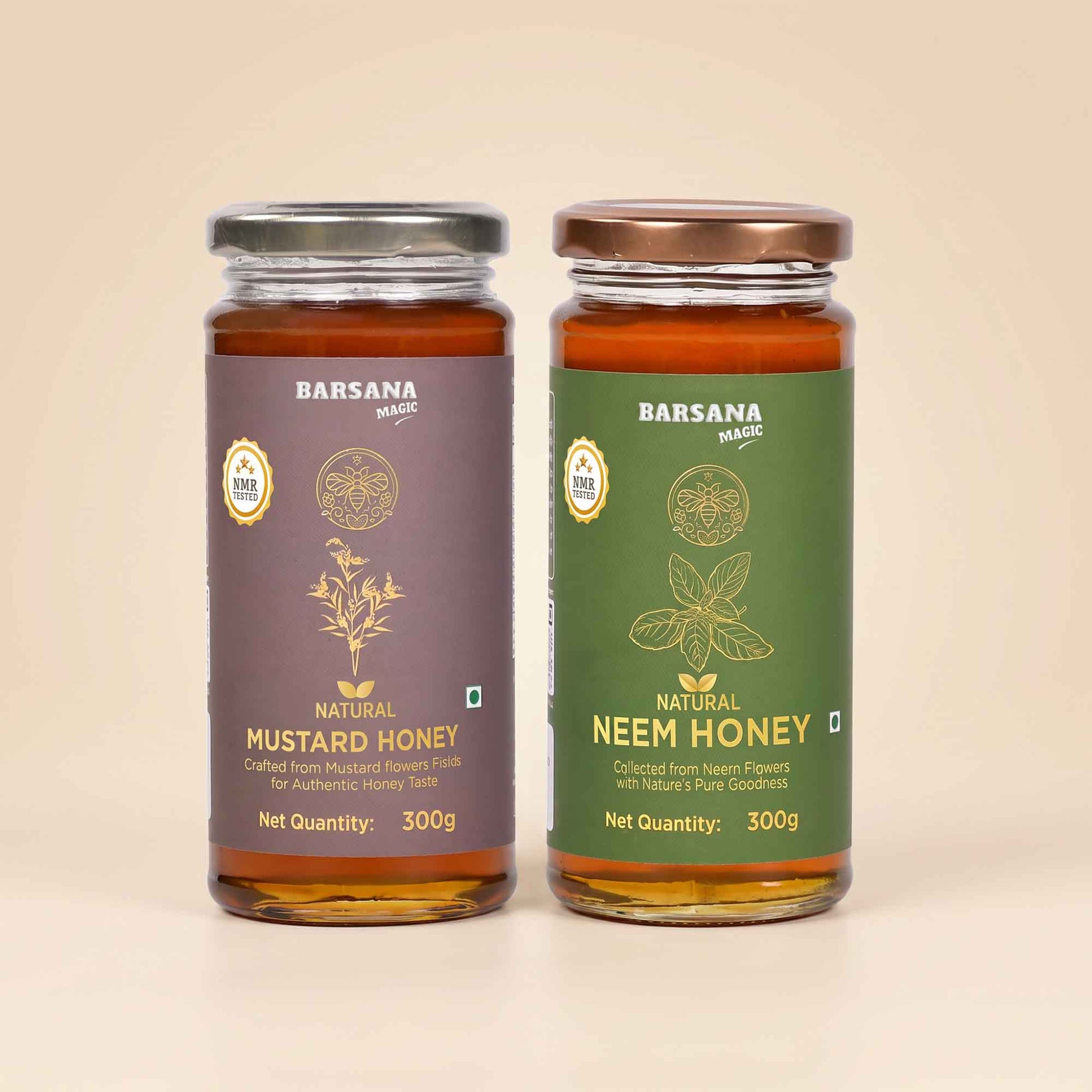 Barsana Magic and Two glass jars of Barsana Magic honey, Natural Mustard Honey on the left with a dark purple label and silver lid, and Natural Neem Honey on the right with a dark green label and bronze lid, set against a solid beige background.