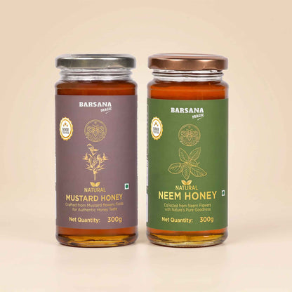Barsana Magic and Two glass jars of Barsana Magic honey, Natural Mustard Honey on the left with a dark purple label and silver lid, and Natural Neem Honey on the right with a dark green label and bronze lid, set against a solid beige background.