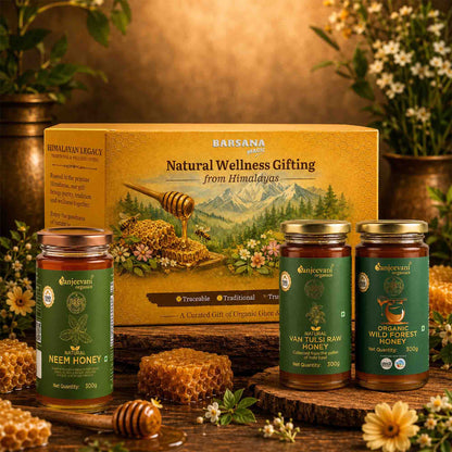 Barsana Magic and Honey products with a decorative box on a wooden surface with flowers and honeycomb.