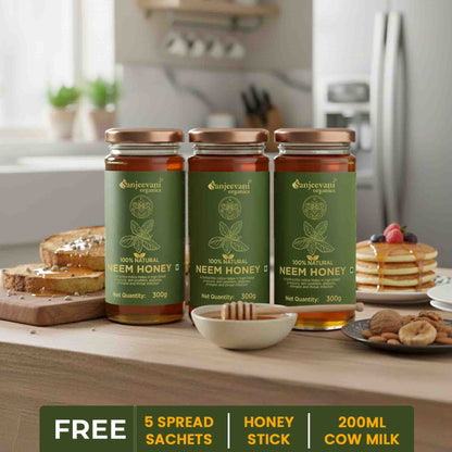 Barsana Magic and  Three jars of Sanjeevani organic Neem Honey on a kitchen counter with food items.