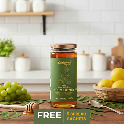 Barsana Magic and Bottle of Sanjeevani Organics Neem Honey on a kitchen counter with fruits and a shelf in the background.