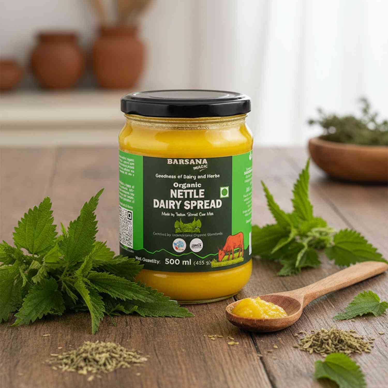 Barsana Magic and Jar of Organic Nettle Dairy Spread on a wooden surface with nettle leaves and a wooden spoon.
