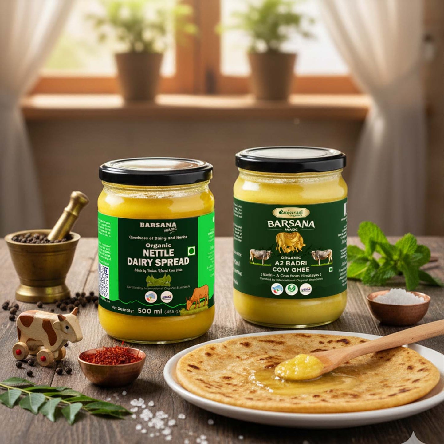 Barsana Magic and Two jars of Barsana dairy products on a wooden table with a plate of flatbread and spread.
