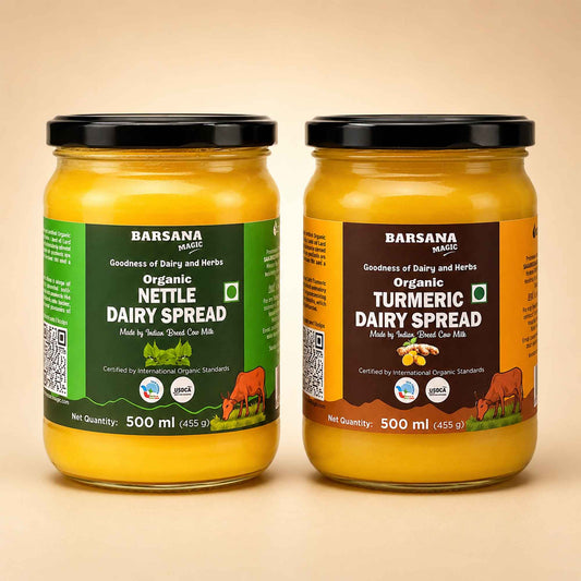 Barsana Magic and Two 500 ml glass jars of Barsana Magic dairy spreads on a beige background. The left jar contains Organic Nettle Dairy Spread with a green label, and the right jar contains Organic Turmeric Dairy Spread with a brown label.