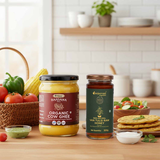 Barsana Magic and Two jars of organic products on a kitchen counter with vegetables and a salad in the background.