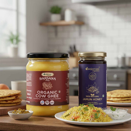 Barsana Magic and Two jars of organic cow ghee and jamun honey on a kitchen counter with food in the background.