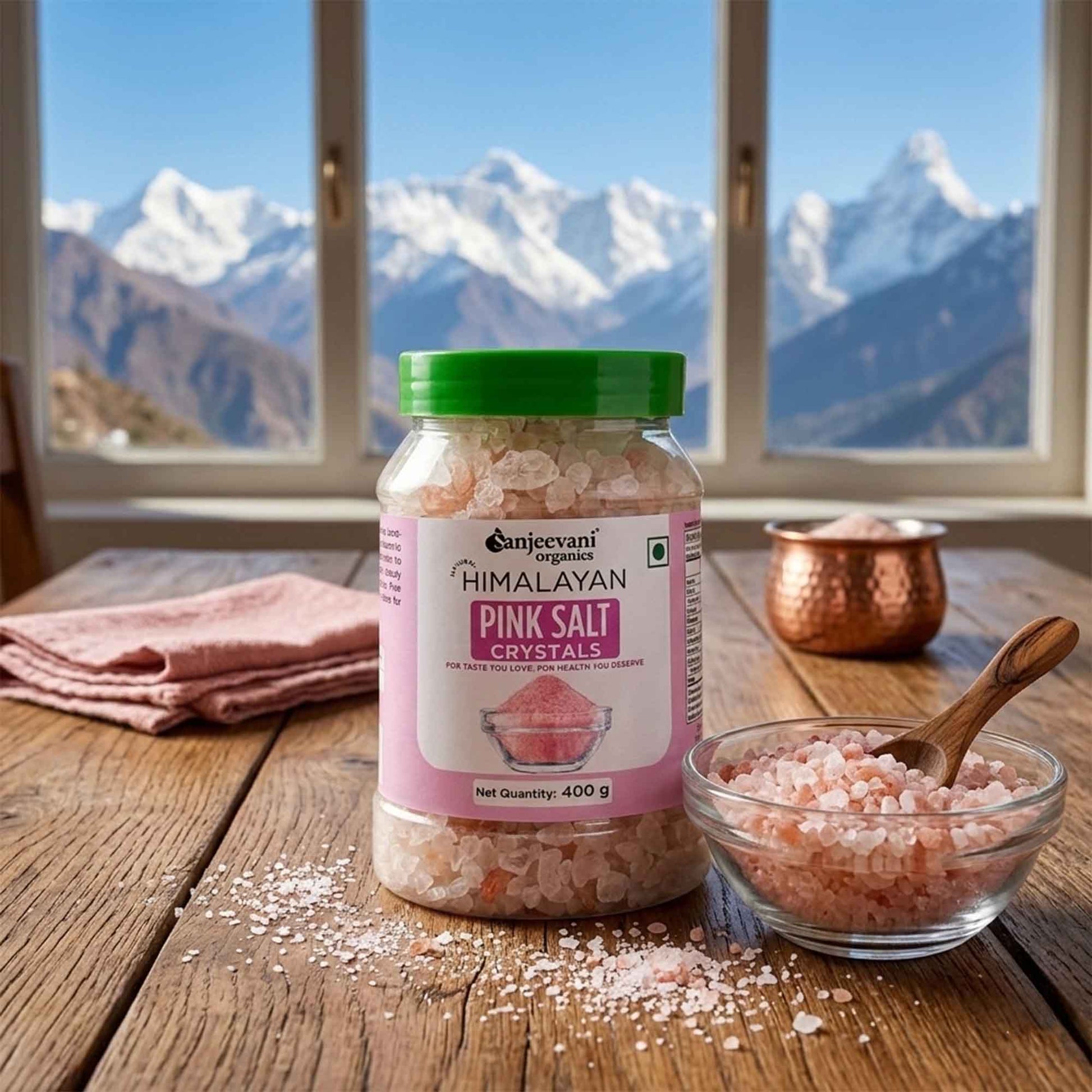 Barsana Magic and Jar of Himalayan pink salt crystals on a wooden table with mountains in the background