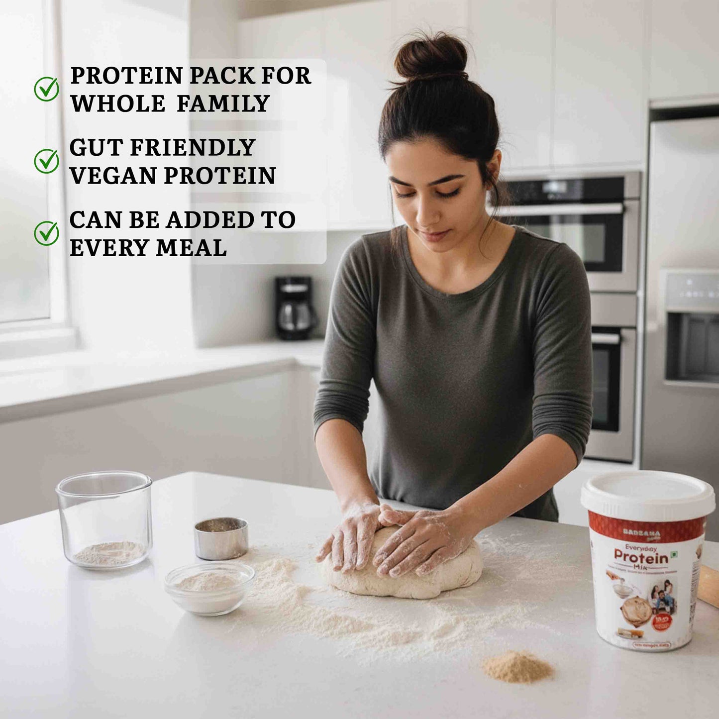 Barsana Magic and Woman in a kitchen preparing food with a protein powder container on the counter.