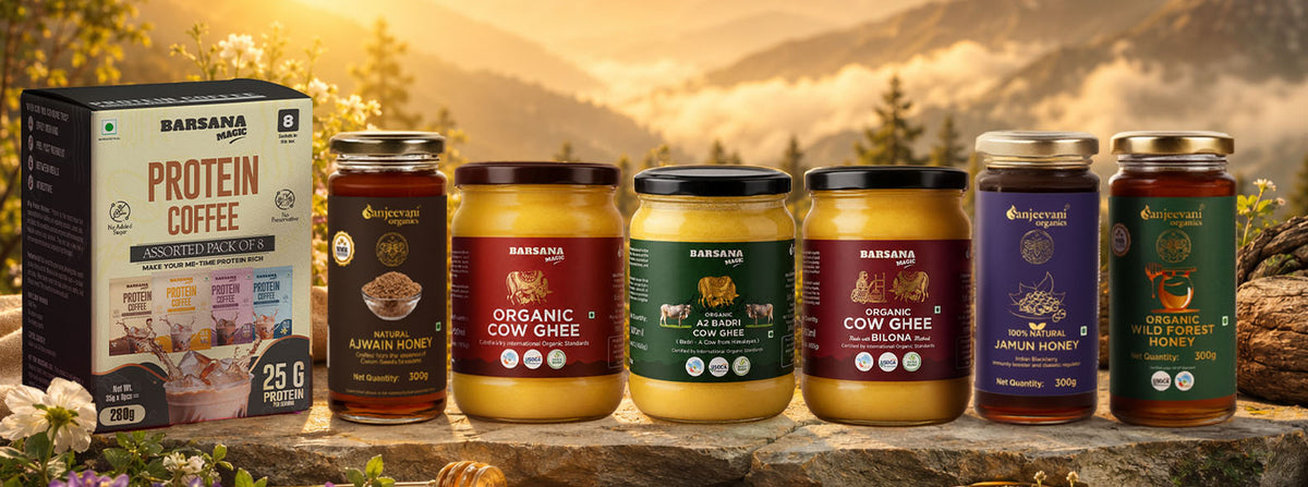Barsana Magic and Bags of products including Protein Coffee and Cow Ghee on a wooden surface with a mountainous background.