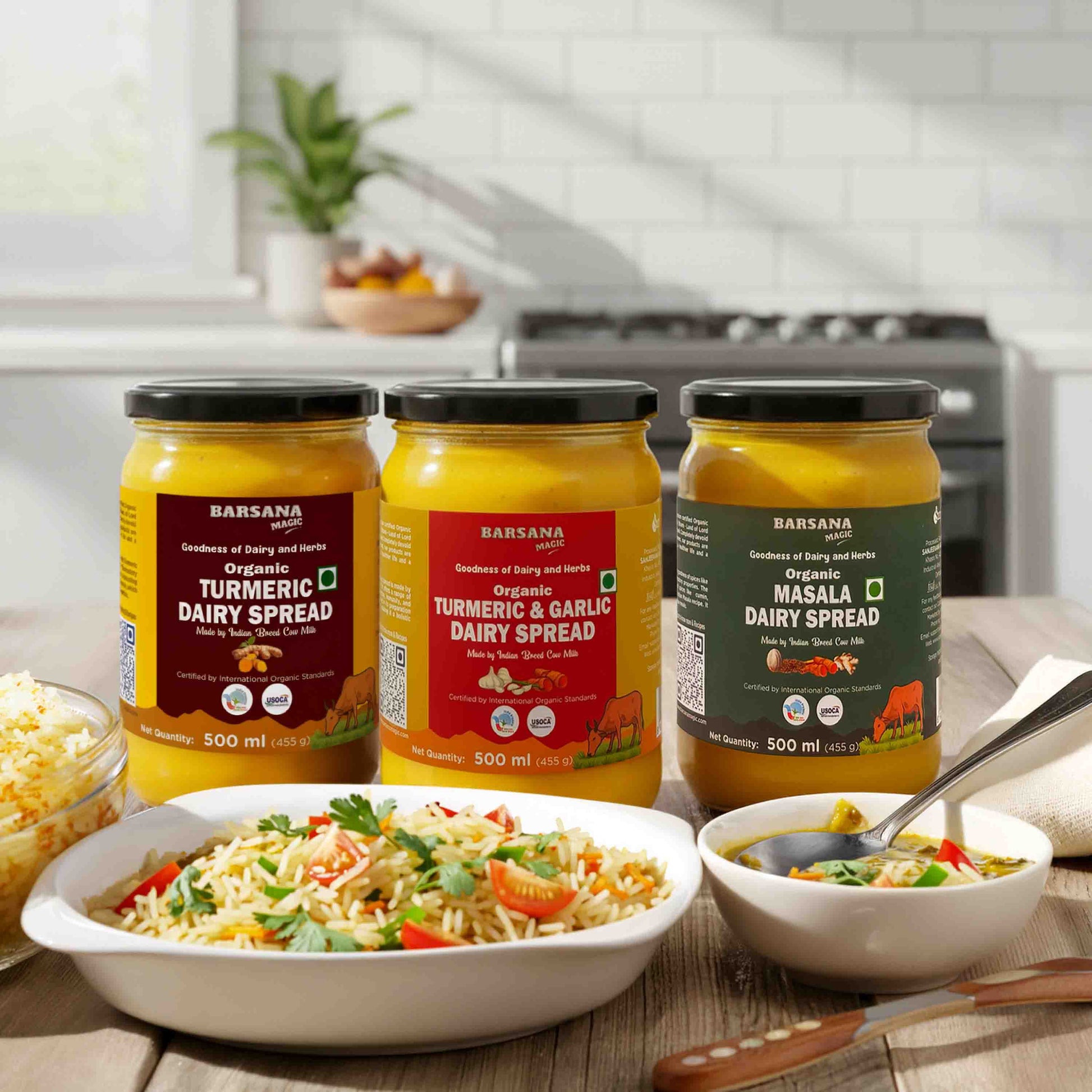 Barsana Magic and  Three jars of dairy spreads on a kitchen counter with food dishes.