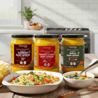 Barsana Magic and  Three jars of dairy spreads on a kitchen counter with food dishes.