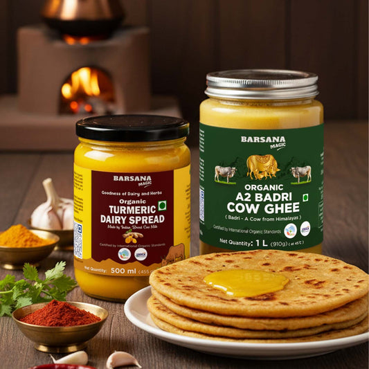 Barsana Magic and Two jars of Barsana dairy products with a plate of roti and spices on a wooden table.