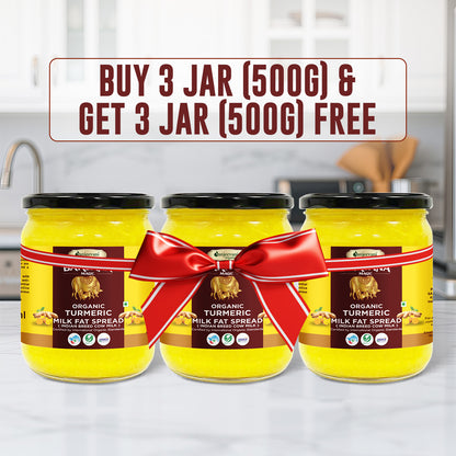 Barsana Magic 3 Jars of turmeric milk fat spread with a red bow on a kitchen counter.