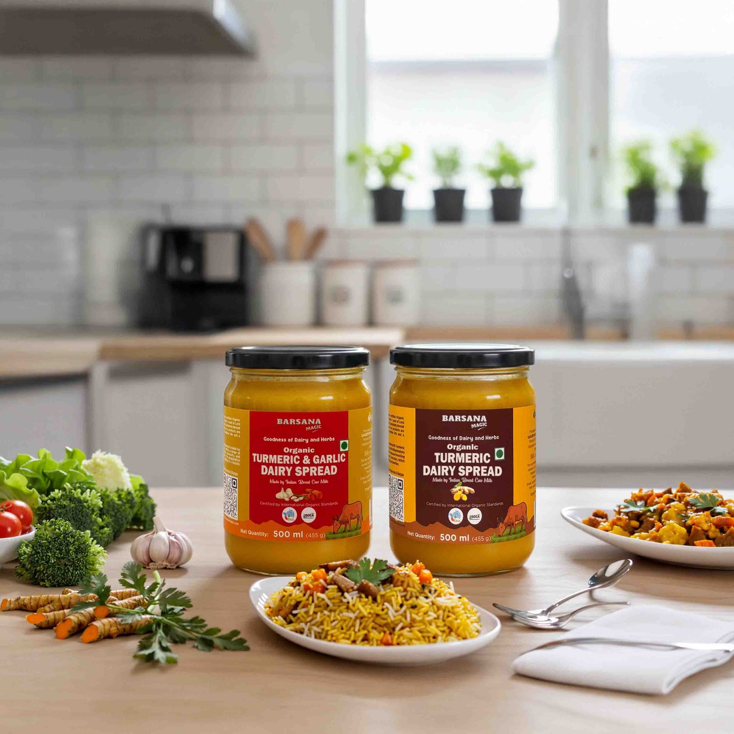 Barsana Magic and  Two jars of Turmeric & Garlic Dairy Spread on a kitchen counter with food and vegetables.