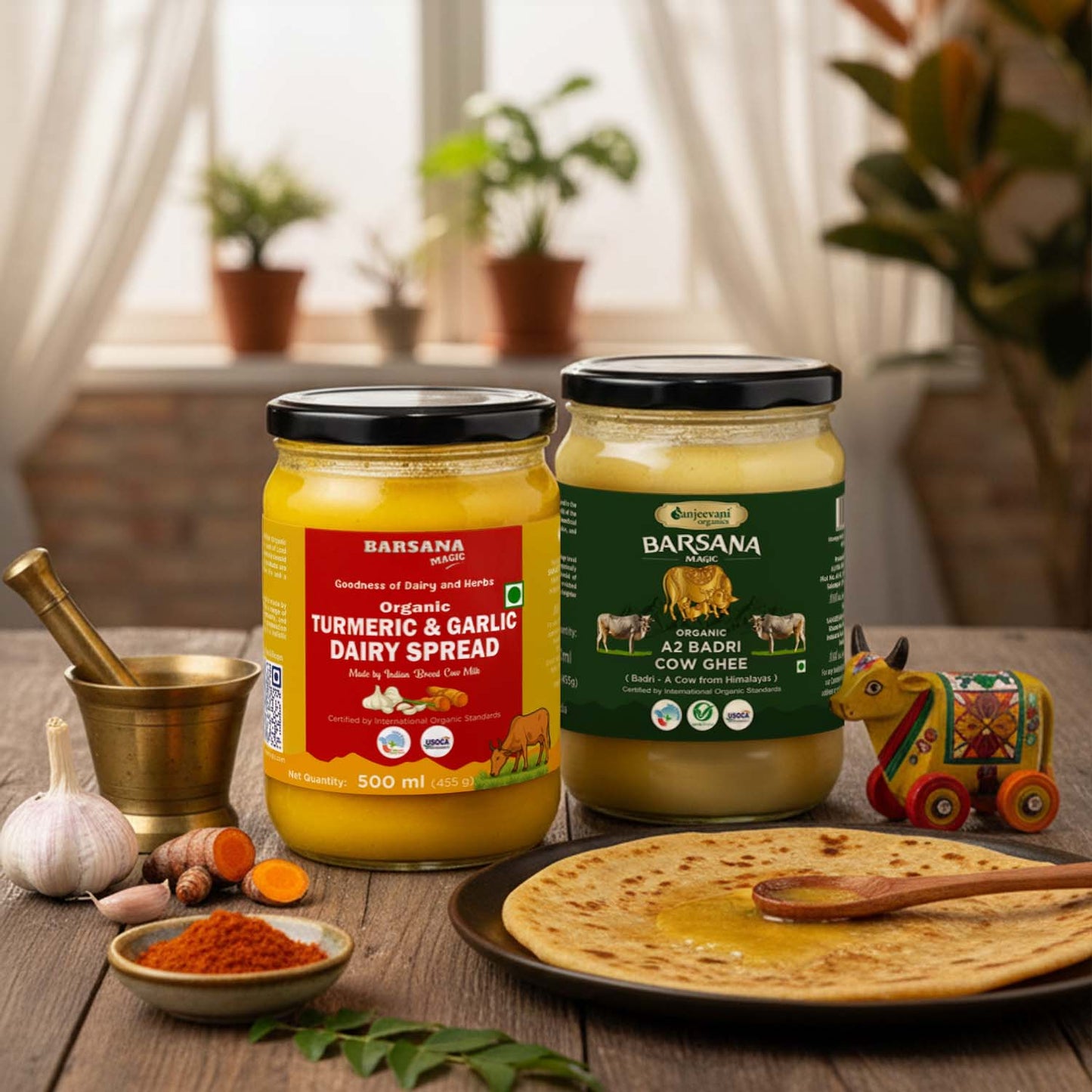 Barsana Magic and Two jars of Barsana dairy products on a wooden table with a plate of roti and spices.