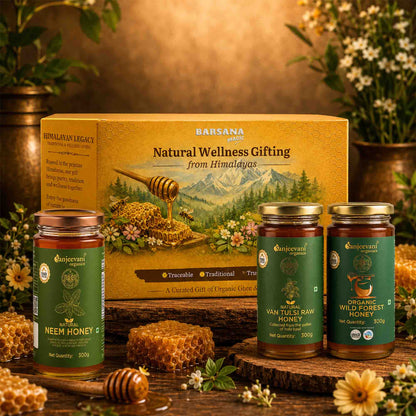Barsana Magic and  Honey products with a decorative box on a wooden surface with flowers and honeycomb.