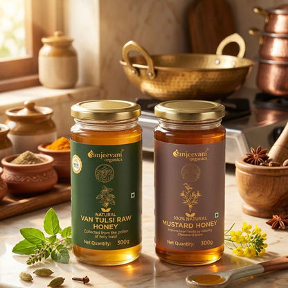 Barsana Magic and Two jars of Sanjeevani Organics honey on a kitchen counter with copper pots and spices in the background.
