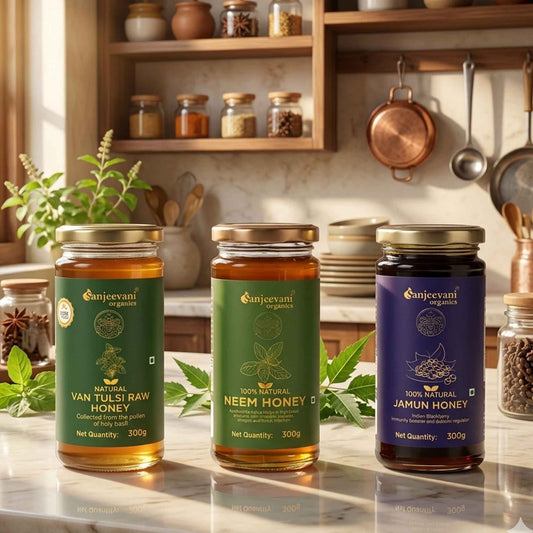 Barsana Magic and Three jars of honey from Sanjeevani Organics on a kitchen counter with shelves in the background.
