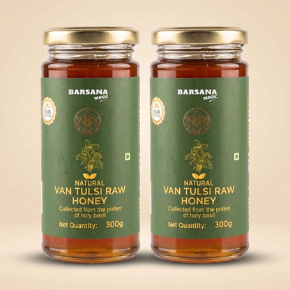 Barsana Magic and Two glass jars of Barsana Magic Natural Van Tulsi Raw Honey with gold lids and green labels, displayed side-by-side on a light beige background.