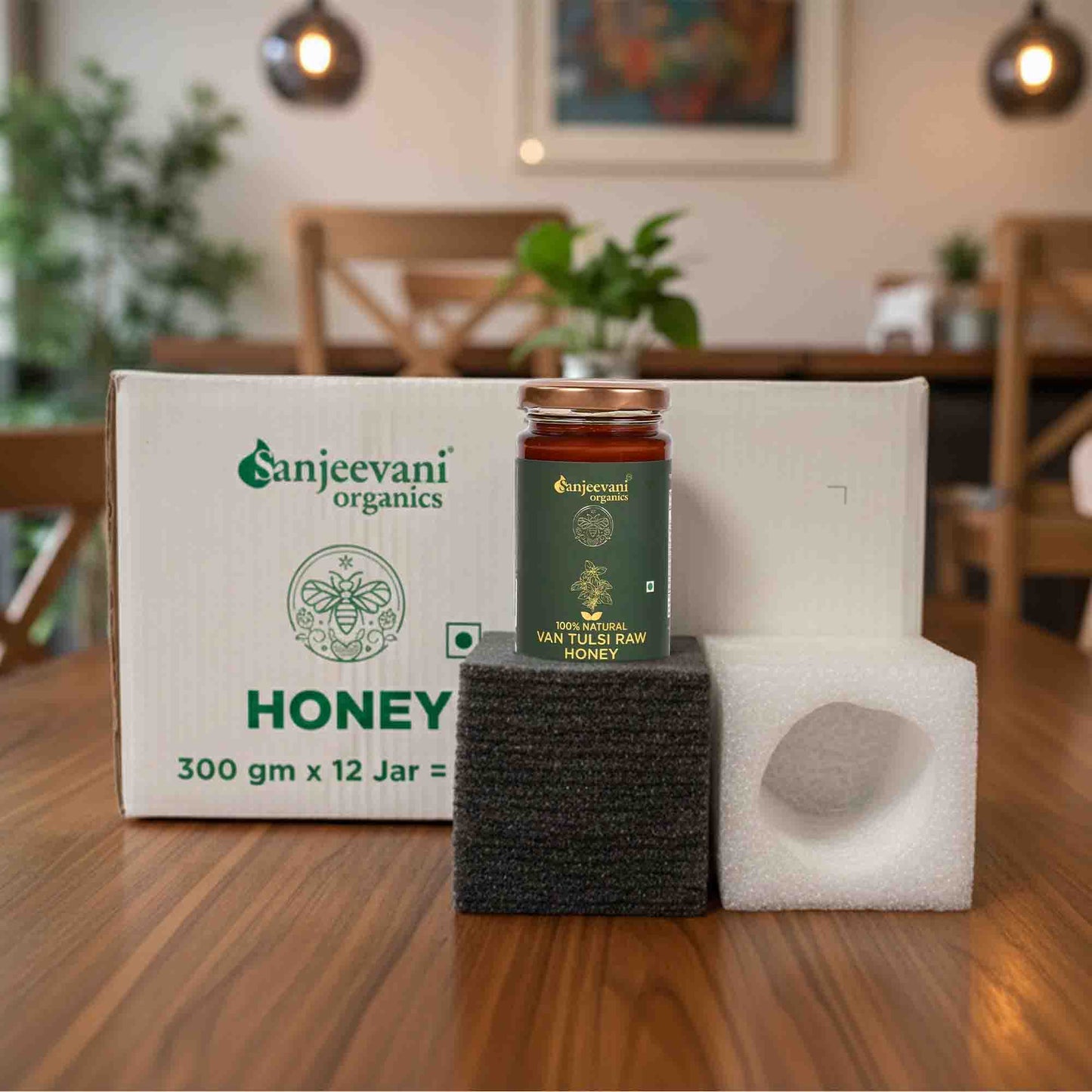Barsana Magic and Organics honey jar and packaging on a wooden table with a blurred background