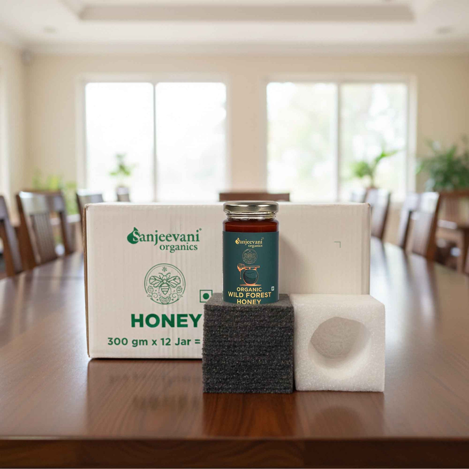 Barsana Magic and Organics honey jar on a wooden table with a blurred background