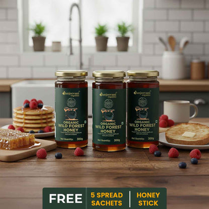 Barsana Magic and Three jars of organic wild forest honey on a kitchen counter with breakfast items.